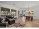 Bright living room features tile floors, plush seating, and a view into the dining area at 9758 E Meseto Ave, Mesa, AZ 85209