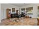 Living room with dark gray sofas, tile flooring, and large windows at 9758 E Meseto Ave, Mesa, AZ 85209