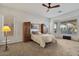 Main bedroom with ceiling fan, large windows, and built-in storage at 9758 E Meseto Ave, Mesa, AZ 85209