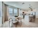 Bright kitchen with an island, white cabinets, and a dining area at 10165 E Ursula Ave, Mesa, AZ 85212