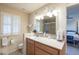 Clean bathroom with double vanity, shower, and white shutters at 11126 W Cameo Dr, Sun City, AZ 85351