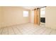 Bright bedroom with tile floors and barn door leading to bathroom at 122 W Washington Ave, Gilbert, AZ 85233