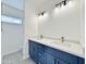 Modern bathroom with double vanity, navy blue cabinets, quartz countertops, and chrome fixtures at 13586 S Kashmir Rd, Arizona City, AZ 85123