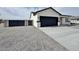 Newly constructed single-story home featuring a modern design, two-car garage, and desert landscaping at 13586 S Kashmir Rd, Arizona City, AZ 85123