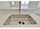 Close-up of a stainless steel kitchen sink with modern faucet and quartz countertops at 13586 S Kashmir Rd, Arizona City, AZ 85123