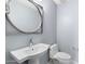 Modern bathroom with white sink and oval mirror at 16510 N 92Nd St # 1003, Scottsdale, AZ 85260