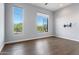 Bright bedroom with large windows and hardwood floors at 16510 N 92Nd St # 1003, Scottsdale, AZ 85260