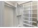 Bright walk-in closet with custom shelving and rods at 16510 N 92Nd St # 1003, Scottsdale, AZ 85260