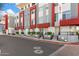 Street view of modern townhomes with red accents at 16510 N 92Nd St # 1003, Scottsdale, AZ 85260