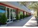 Building exterior with red accents, glass doors, and landscaping at 16510 N 92Nd St # 1003, Scottsdale, AZ 85260