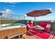 Rooftop hot tub with seating and patio umbrella at 16510 N 92Nd St # 1003, Scottsdale, AZ 85260