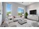 Bright living room with large windows, comfortable seating, and modern decor at 16510 N 92Nd St # 1003, Scottsdale, AZ 85260