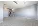 Open loft with carpeted floors and a modern staircase at 16510 N 92Nd St # 1003, Scottsdale, AZ 85260