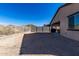 Large backyard with gravel, block wall, and mountain views at 17244 W Lynx Rd, Goodyear, AZ 85338
