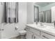 Clean bathroom with white vanity and gray curtains at 17244 W Lynx Rd, Goodyear, AZ 85338