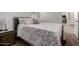 Bedroom with floral bedding and nightstand next to the bed at 17244 W Lynx Rd, Goodyear, AZ 85338