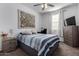 Comfortable guest bedroom with a dresser and ceiling fan at 17244 W Lynx Rd, Goodyear, AZ 85338