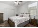 Bedroom with floral bedding, nightstand, and double doors at 17244 W Lynx Rd, Goodyear, AZ 85338