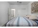 Bright bedroom with striped bedding and double doors leading to the closet at 17244 W Lynx Rd, Goodyear, AZ 85338