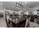 Kitchen and dining area with modern lighting and seating for six at 17244 W Lynx Rd, Goodyear, AZ 85338