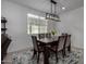 Bright dining room featuring a modern chandelier and seating for six at 17244 W Lynx Rd, Goodyear, AZ 85338