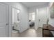 Bright hallway with entryway table, bathroom, and bedroom at 17244 W Lynx Rd, Goodyear, AZ 85338