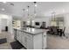 Open kitchen with large island, stainless steel appliances, and dining area at 17244 W Lynx Rd, Goodyear, AZ 85338