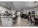 Open concept kitchen with island, dining area, and living room view at 17244 W Lynx Rd, Goodyear, AZ 85338