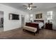 Spacious main bedroom with a ceiling fan and ensuite bathroom at 17244 W Lynx Rd, Goodyear, AZ 85338