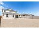 Gravel backyard with a two-story house and privacy fence at 17631 W Sanna St, Waddell, AZ 85355