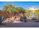 Landscaped backyard with a beautiful rock waterfall feature at 18064 W Buena Vista Dr, Surprise, AZ 85374