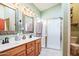 Clean bathroom with double vanity, shower, and separate toilet at 18064 W Buena Vista Dr, Surprise, AZ 85374