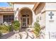 Front entry with arched doorway and decorative accents at 18064 W Buena Vista Dr, Surprise, AZ 85374