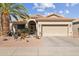 House exterior with palm tree and a paved driveway at 18064 W Buena Vista Dr, Surprise, AZ 85374