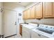 Laundry room with washer, dryer, and ample cabinet storage at 18064 W Buena Vista Dr, Surprise, AZ 85374