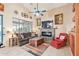 Cozy living room featuring a fireplace and ample natural light at 18064 W Buena Vista Dr, Surprise, AZ 85374