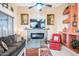 Living room with fireplace, comfortable seating, and large TV at 18064 W Buena Vista Dr, Surprise, AZ 85374