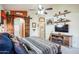 Main bedroom with barn doors, king bed, and large TV at 18064 W Buena Vista Dr, Surprise, AZ 85374