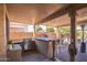 Outdoor kitchen with built-in grill and bar area at 18064 W Buena Vista Dr, Surprise, AZ 85374
