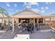 Large backyard patio with seating, bar, and fire pit at 18064 W Buena Vista Dr, Surprise, AZ 85374