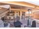 Covered patio with seating area and fire pit at 18064 W Buena Vista Dr, Surprise, AZ 85374