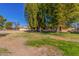 Large backyard with mature trees and grassy area at 18202 N 99Th Dr, Sun City, AZ 85373