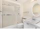 Clean bathroom with shower, white vanity, and mirror at 18202 N 99Th Dr, Sun City, AZ 85373