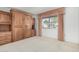 Bedroom with wood built-in shelving and window at 18202 N 99Th Dr, Sun City, AZ 85373