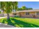 Brick ranch house with a large weeping willow tree and well-manicured lawn at 18202 N 99Th Dr, Sun City, AZ 85373