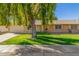 Brick ranch house with a large weeping willow tree and well-manicured lawn at 18202 N 99Th Dr, Sun City, AZ 85373