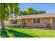 Brick ranch house with a large weeping willow tree and well-manicured lawn at 18202 N 99Th Dr, Sun City, AZ 85373