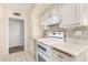 View of kitchen stove, oven, and cabinetry at 18202 N 99Th Dr, Sun City, AZ 85373