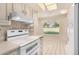 White appliances and cabinetry in this well-lit kitchen at 18202 N 99Th Dr, Sun City, AZ 85373