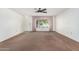 Living room with ceiling fan and large window at 18202 N 99Th Dr, Sun City, AZ 85373